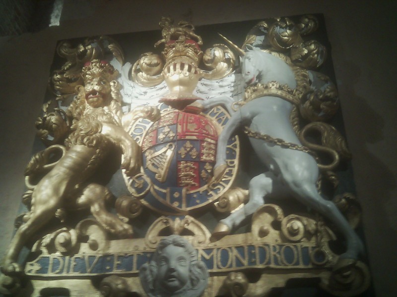 Coat of Arms - (meaning God and my right) is the motto of the Monarch of the United Kingdom in England. It appears on a scroll beneath the shield of the English version of the coat of arms of the United Kingdom